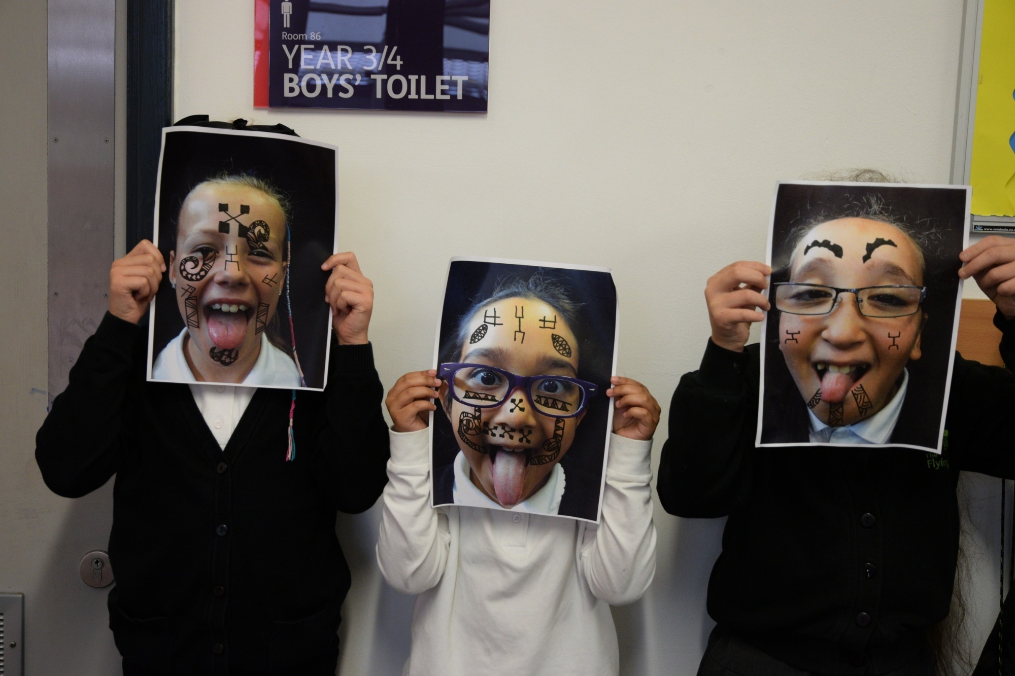 Children holding up images of their face