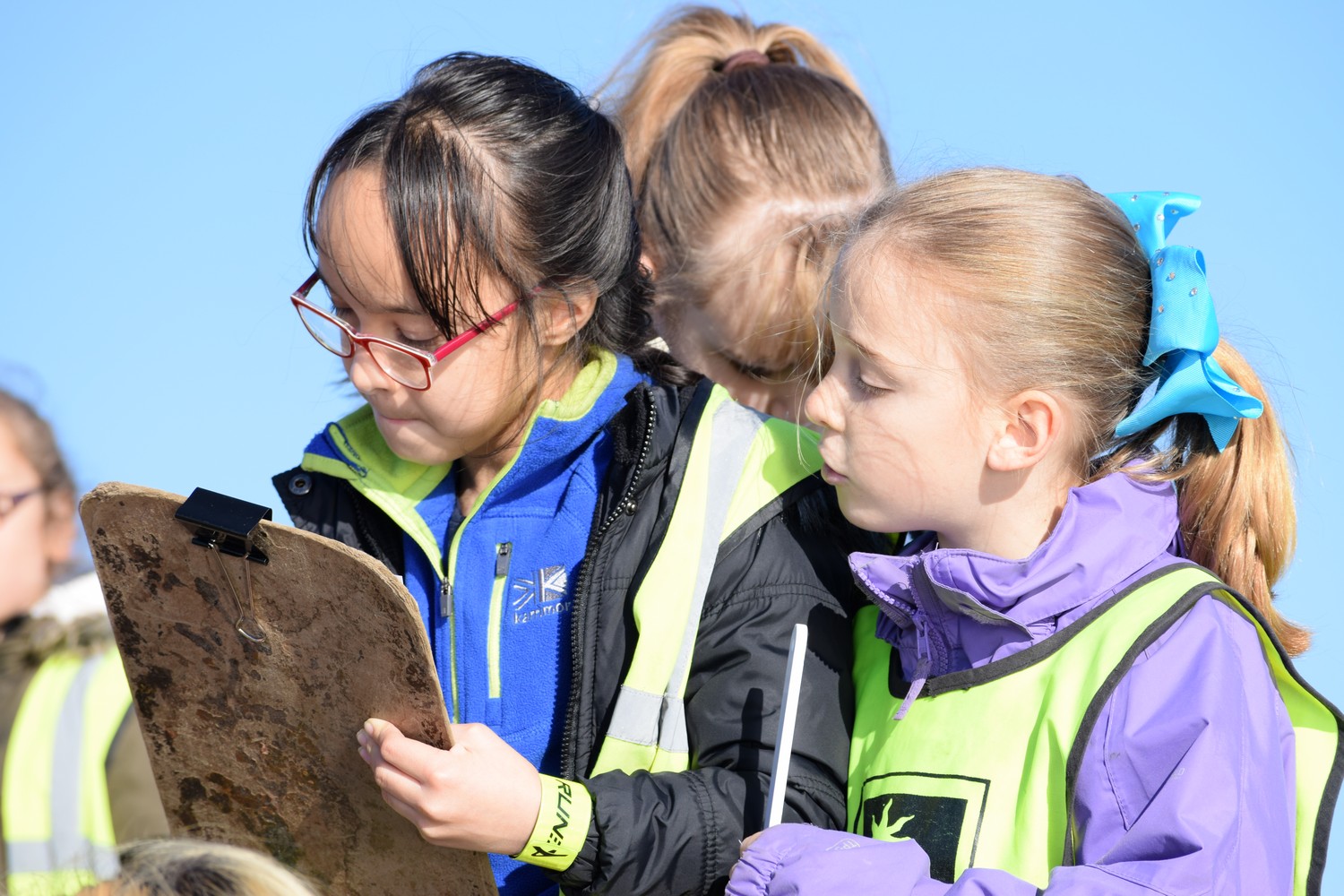 Children outside looking at clipboards